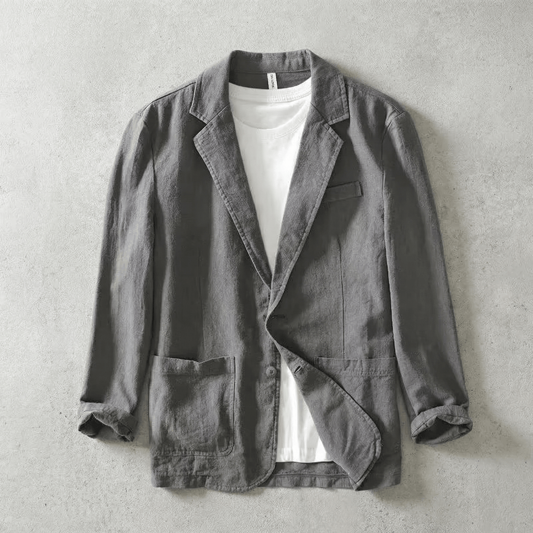 Gray men's tailored blazer jacket layered over a white t-shirt