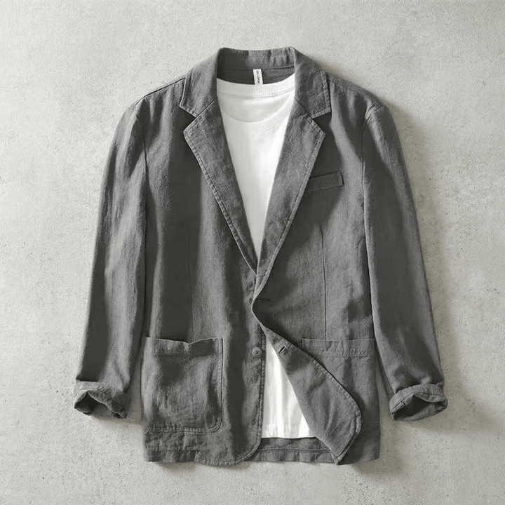 Gray men's tailored blazer jacket layered over a white t-shirt