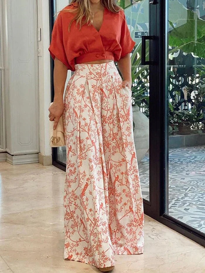 Woman wearing a red and white floral wide-leg two-piece co-ord set