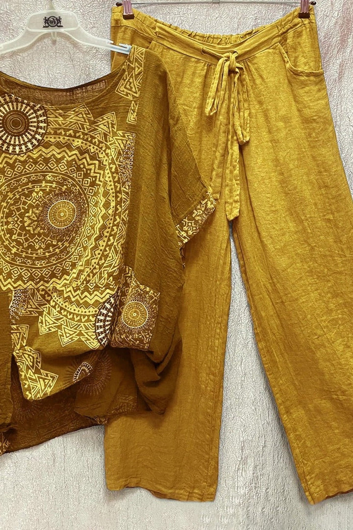 Women's yellow mandala print short sleeve top and wide leg trouser set hanging on display