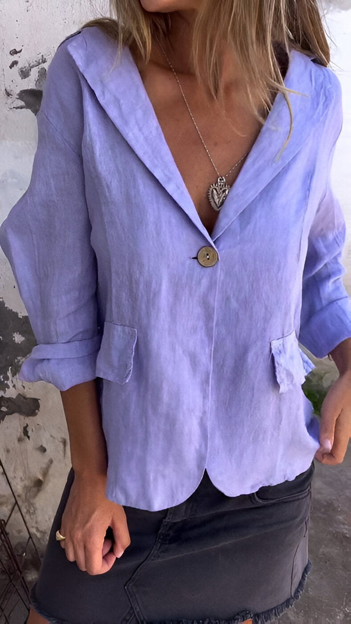 Close-up view of the purple button-front jacket showing pocket details