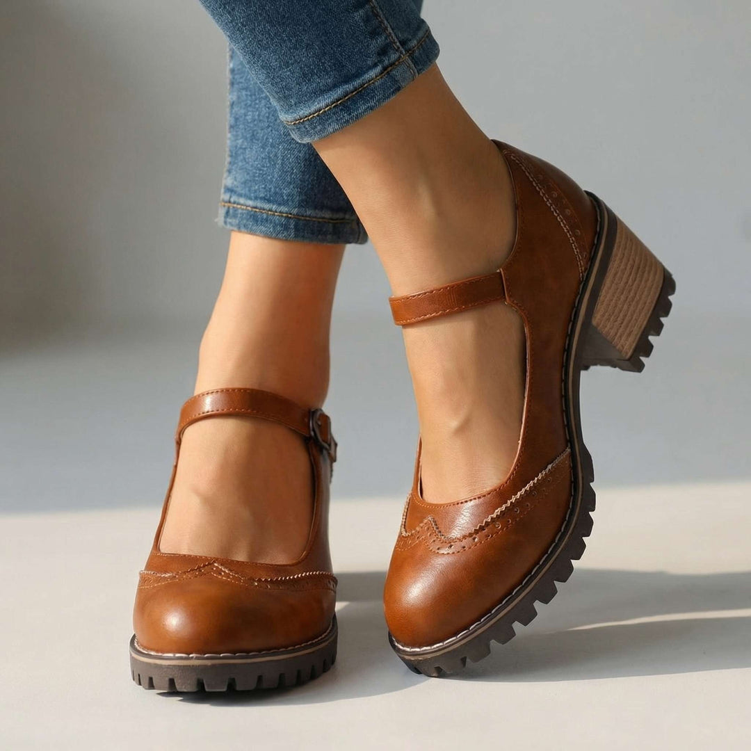 Brown women's retro brogue Mary Jane shoes paired with denim jeans