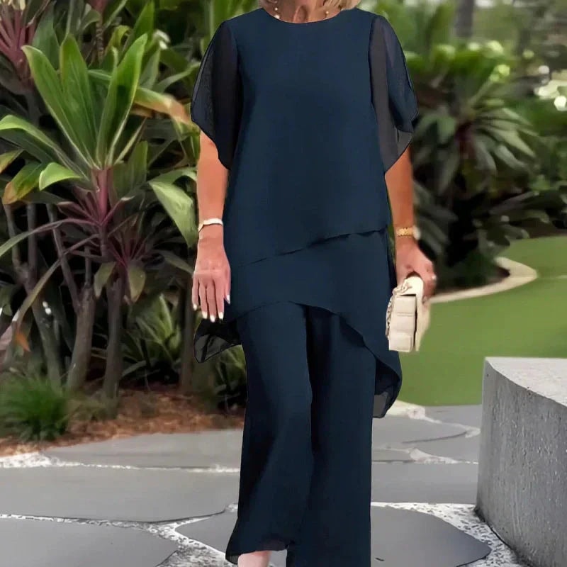Close-up of the flowing double-layer draped top and wide-leg trousers ensemble