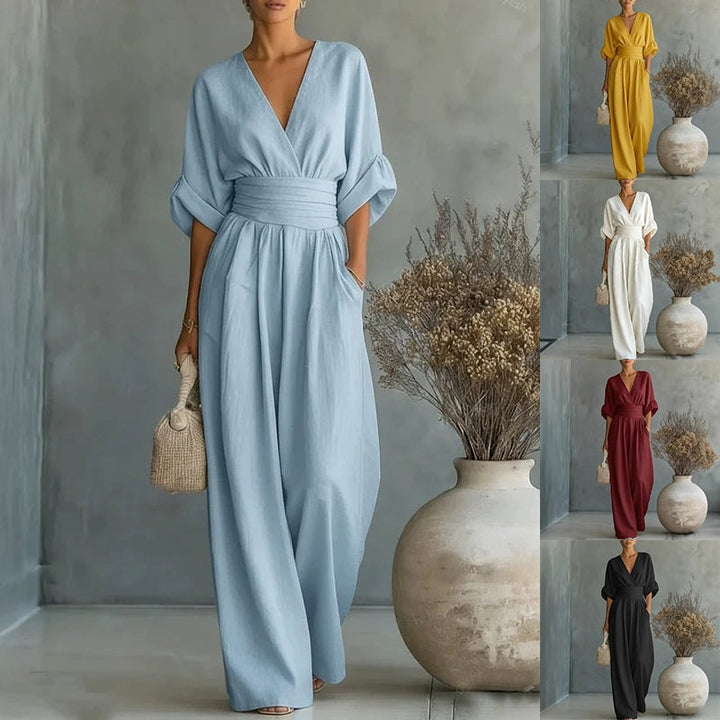 Light blue wide-leg wrap jumpsuit showcased in a studio setting with a decorative vase and thumbnail previews of other color