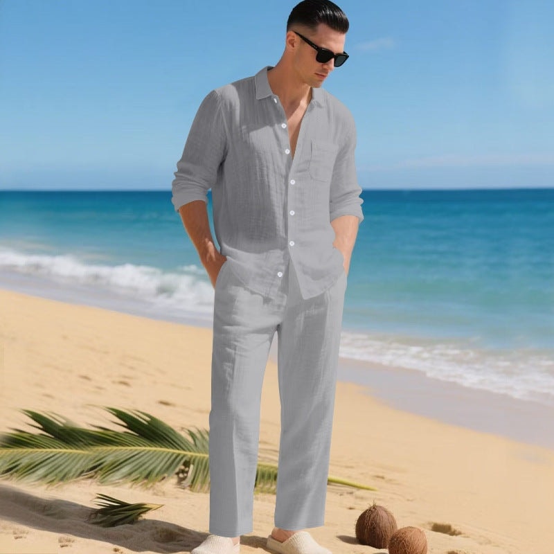 Man wearing a gray matching long-sleeve shirt and trousers set on a beach