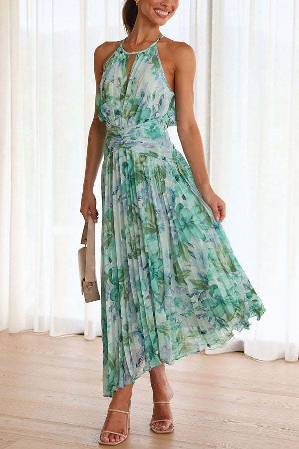 Full view of women's pleated floral maxi dress with keyhole neckline indoors