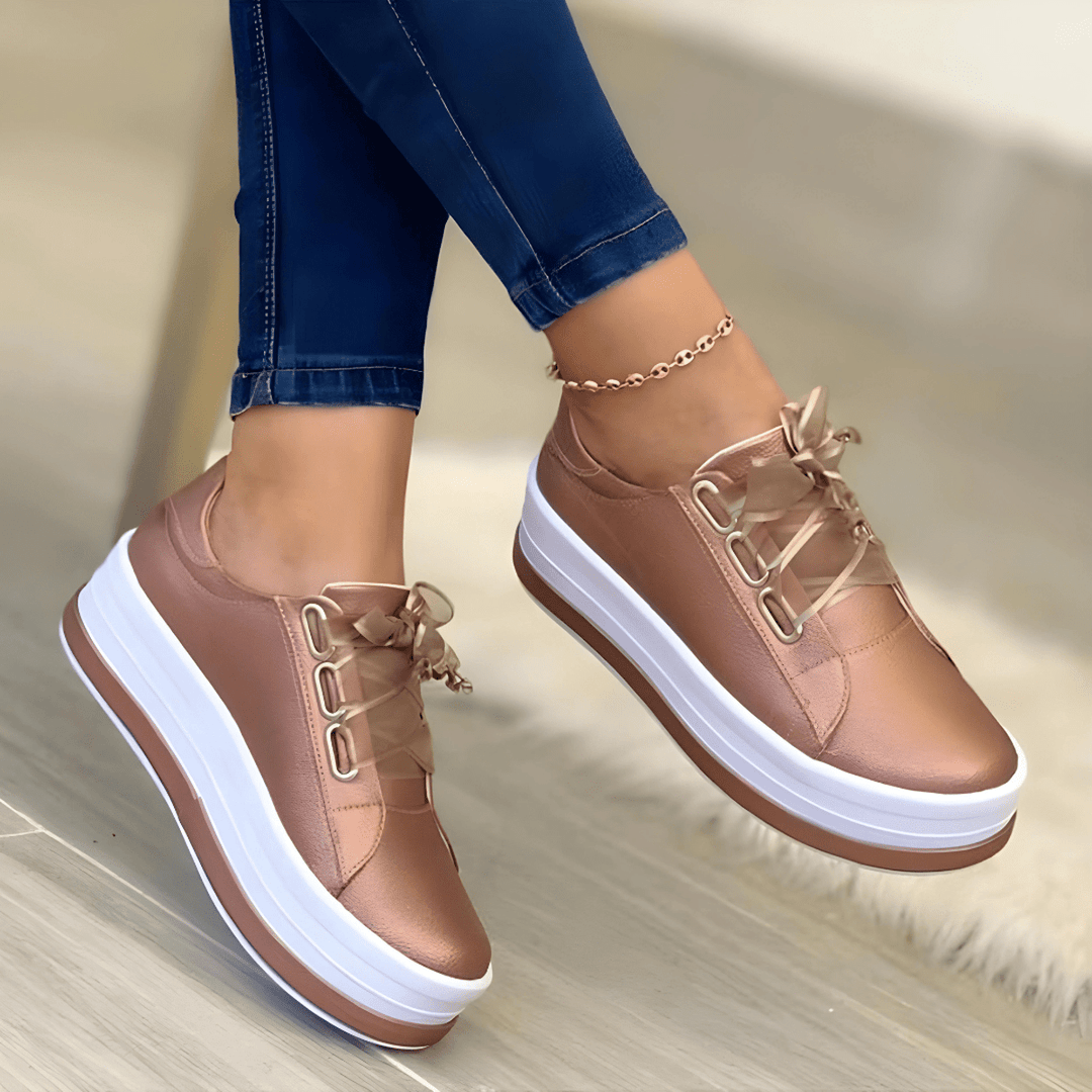 Gold women's platform sneakers with metallic eyelets