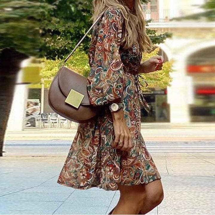 Side profile view of the flowing hemline and balloon sleeves on the boho mini dress.