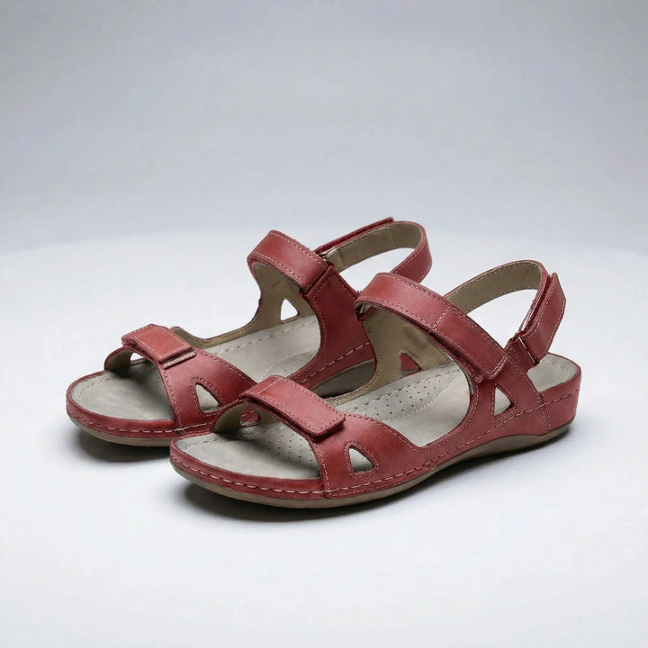 Red orthopedic walking sandals featuring cut-out details and hook-and-loop closures