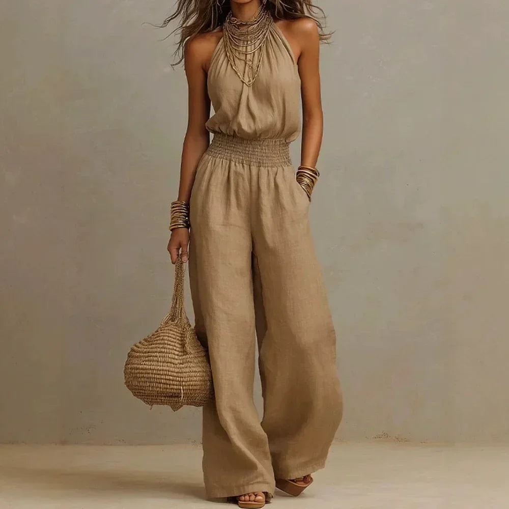 Woman wearing a brown halter neck wide leg jumpsuit with statement accessories
