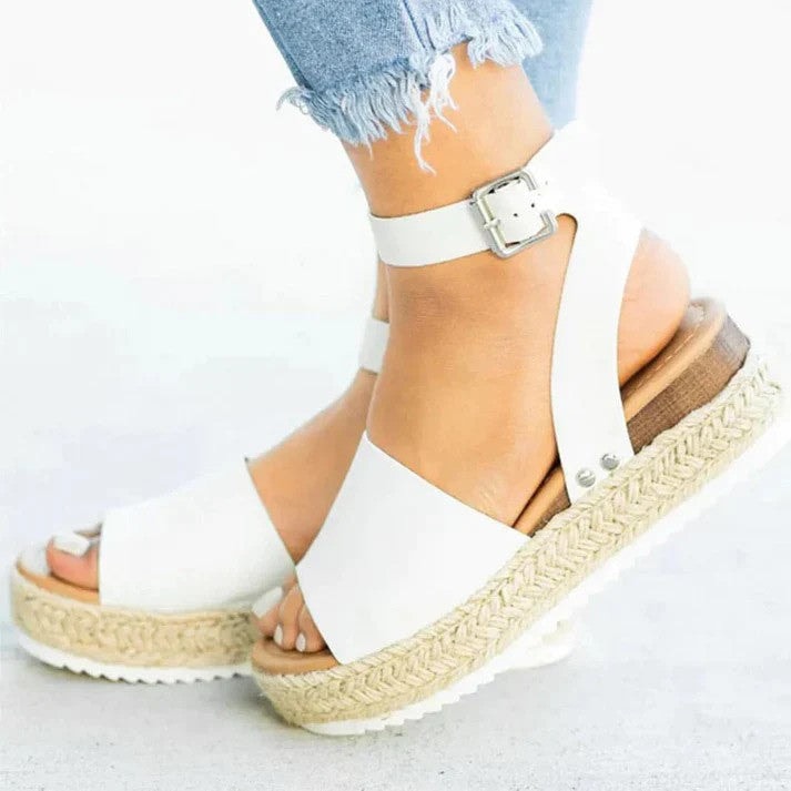 Close-up of women wearing white platform espadrille wedge sandals