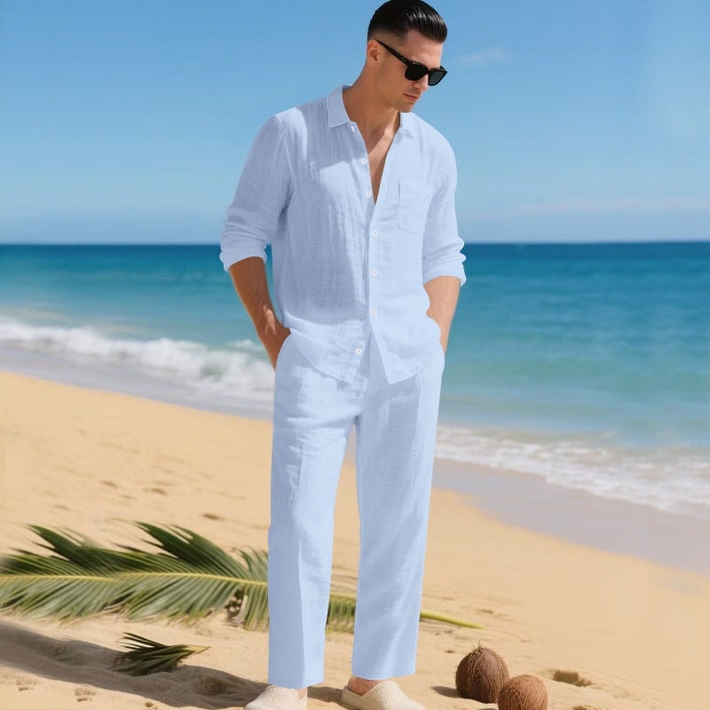 Man wearing a blue matching long-sleeve shirt and trousers set on a beach