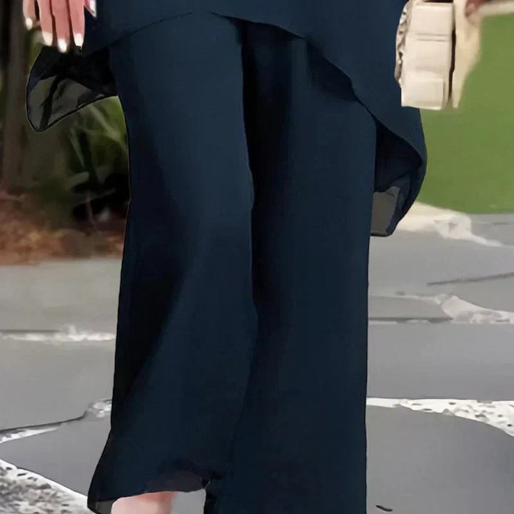 Women's elegant draped two-piece set featuring a flowing top and matching wide leg pants