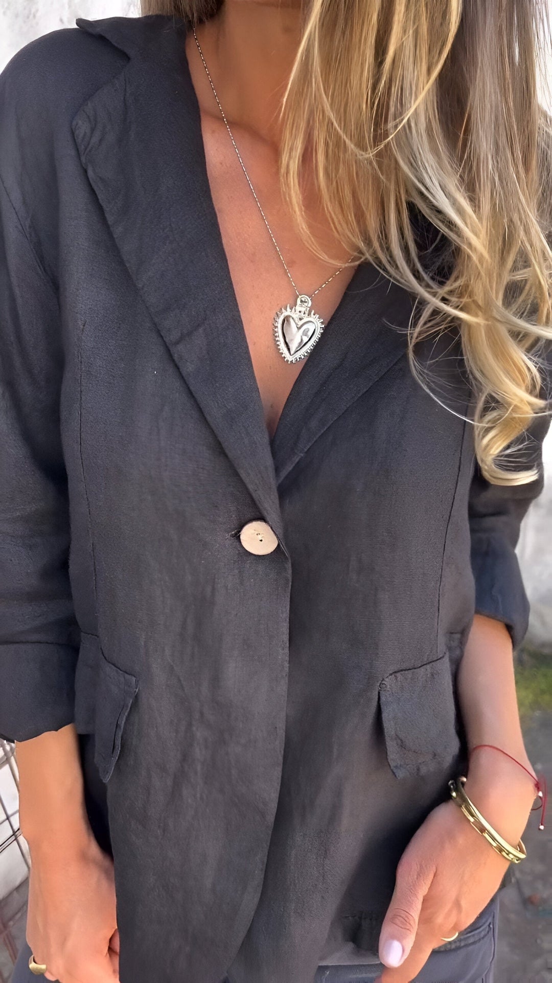 Womens notch-lapel tailored jacket showing structured shoulders and button closure