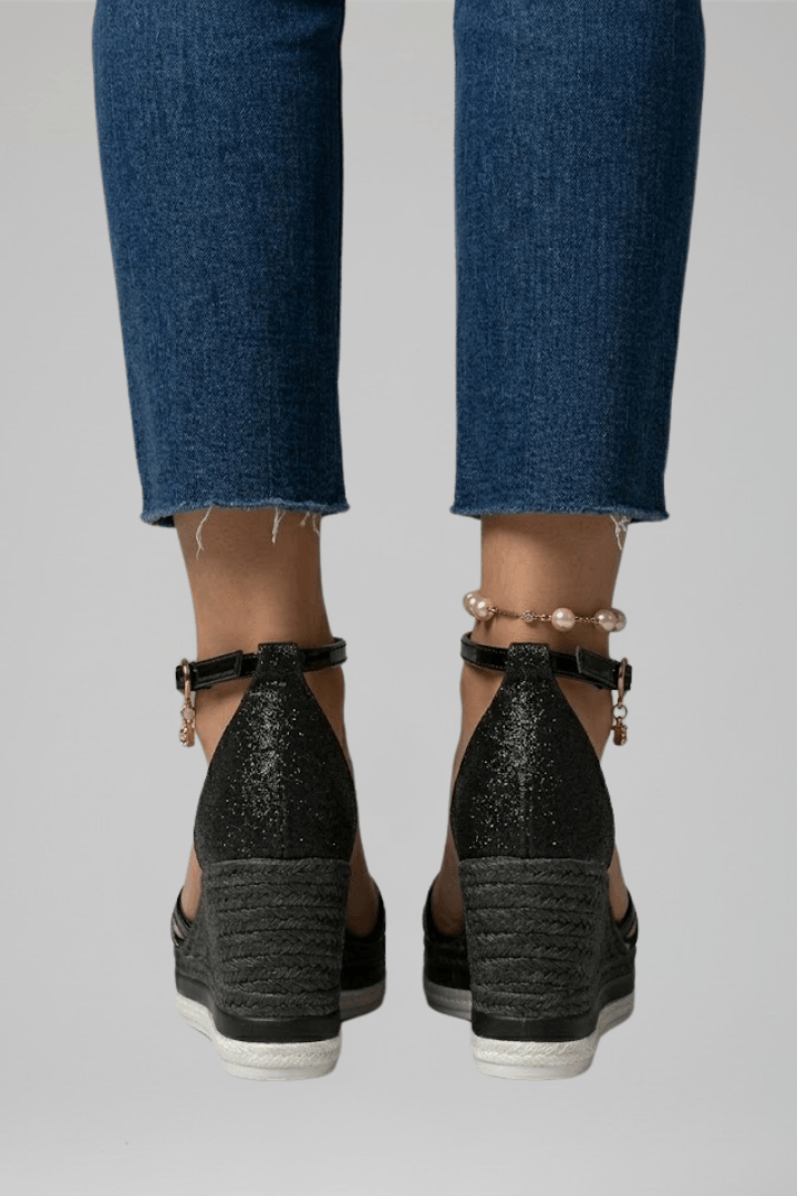 Close-up of glitter platform sandals for women highlighting textured footbed and sparkle