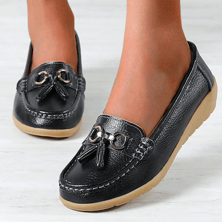 Side view of women's casual tassel loafers showing flexible walking shoe sole