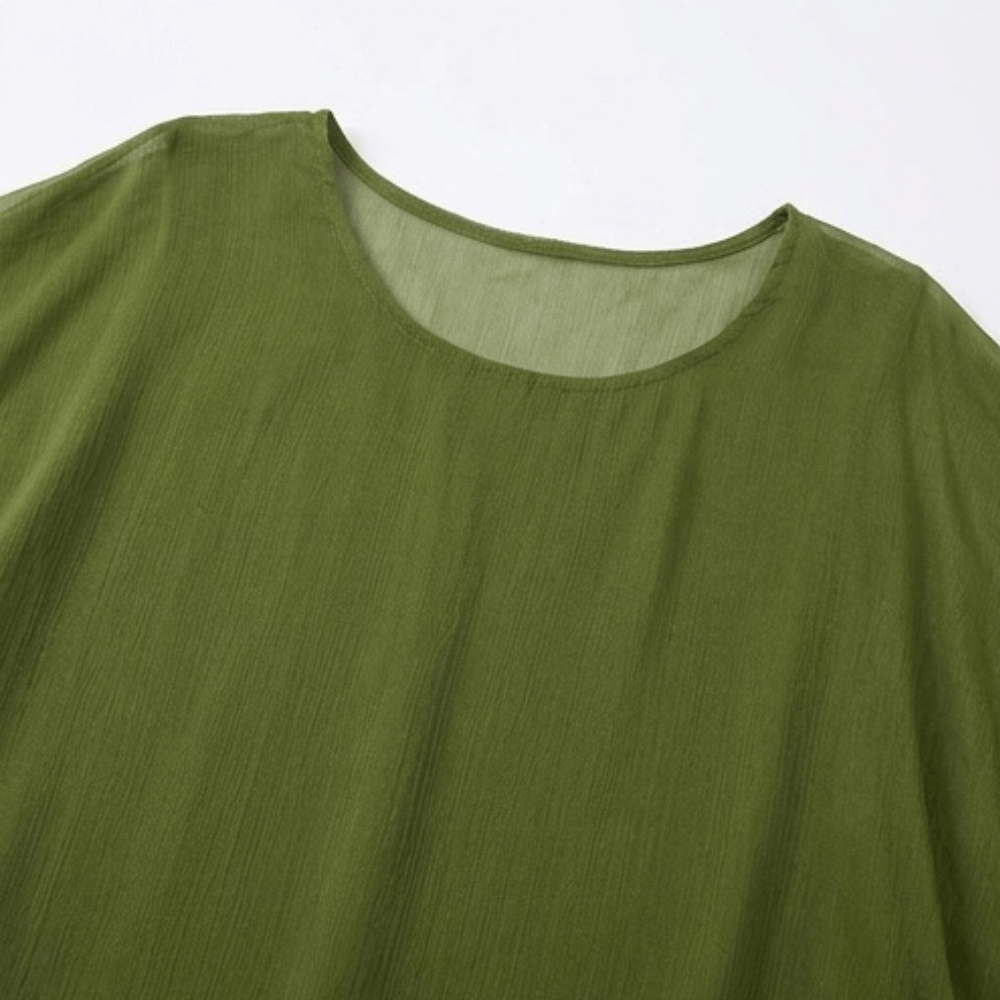 Detail of batwing sleeves on stylish tiered chiffon dress