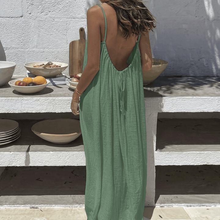 Model walking outdoors wearing a flowy plus size maxi dress