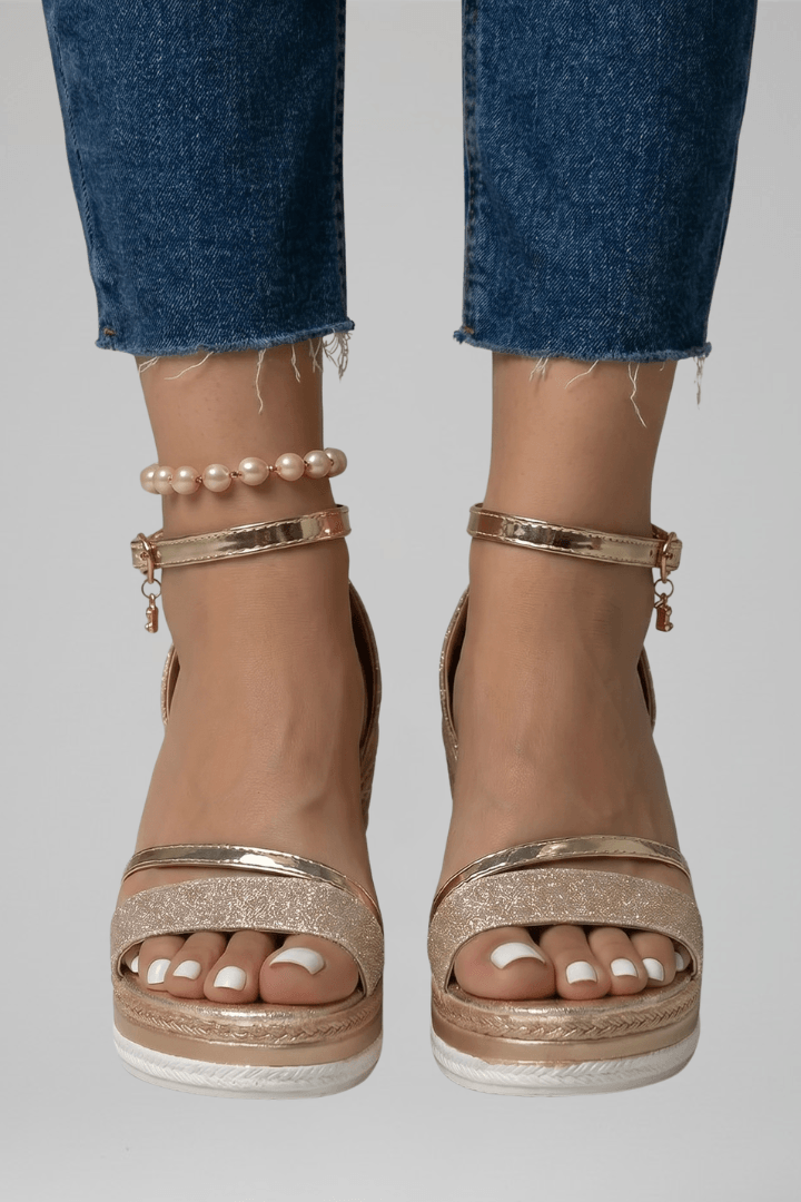 Pair of stylish summer shoes resting on sand showcasing versatile beachwear style