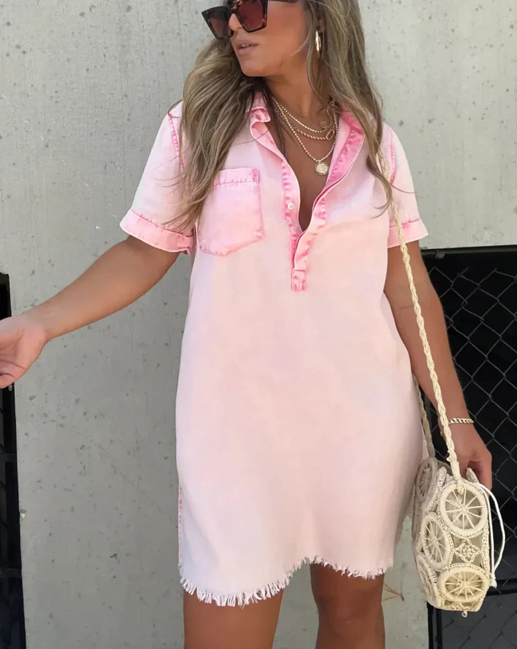 Close-up of metal button details and chest pocket on a casual denim dress