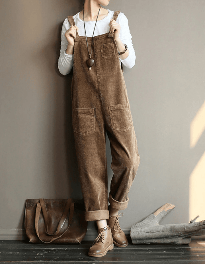 Woman wearing a brown relaxed pocket dungaree jumpsuit with adjustable straps