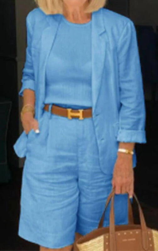Close up of woman in light blue blazer shorts suit set with brown belt