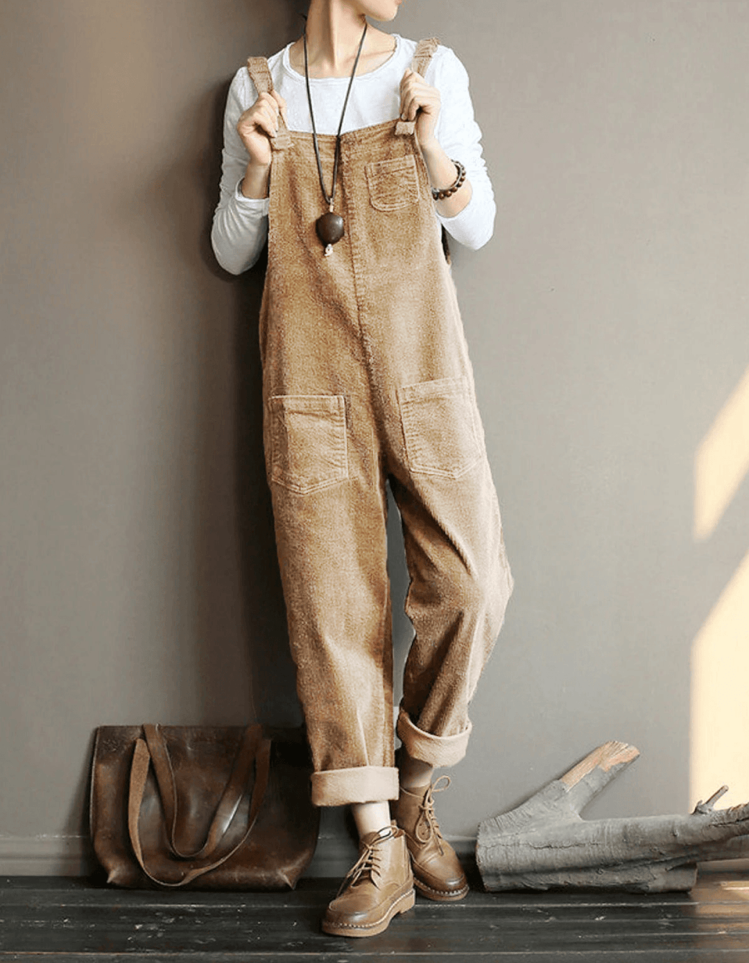 Full view of the brown relaxed pocket dungaree jumpsuit with layered styling