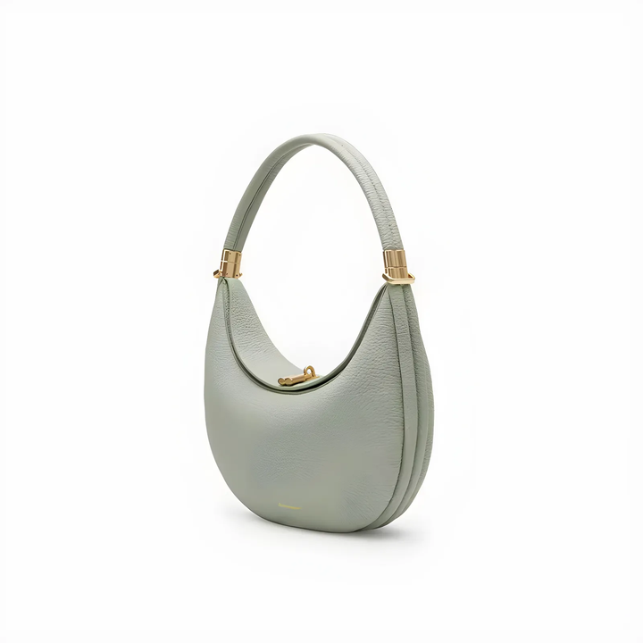 Versatile fashion accessory crescent bag resting on a table, perfect for daily wear.