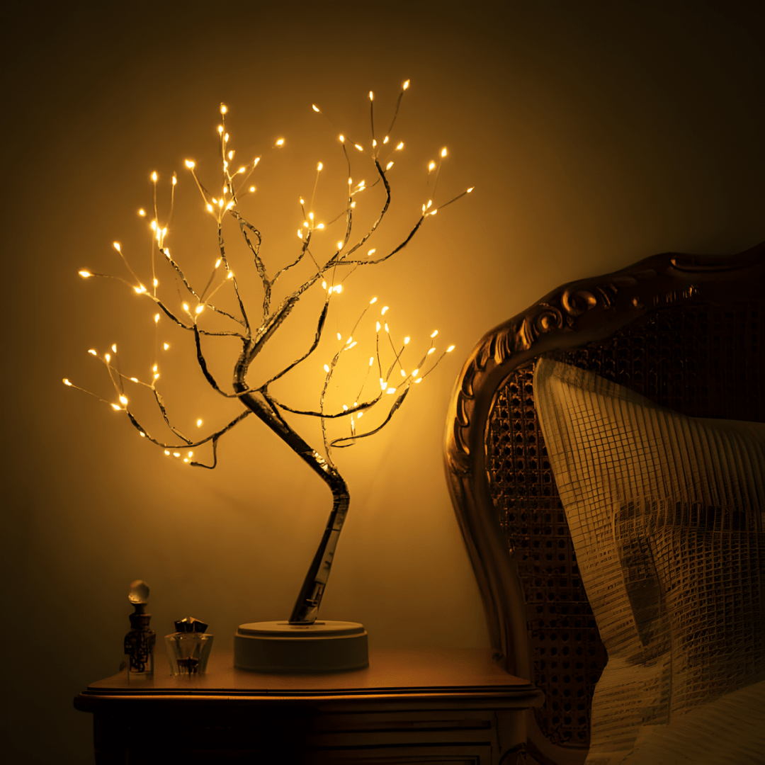 Illuminated Tulip Tree Lamp glowing warmly on a nightstand beside a bed