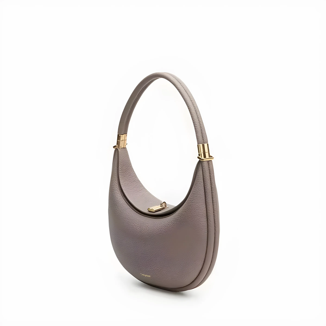 Elegant women's shoulder bag displayed against a neutral background, highlighting fashion appeal.
