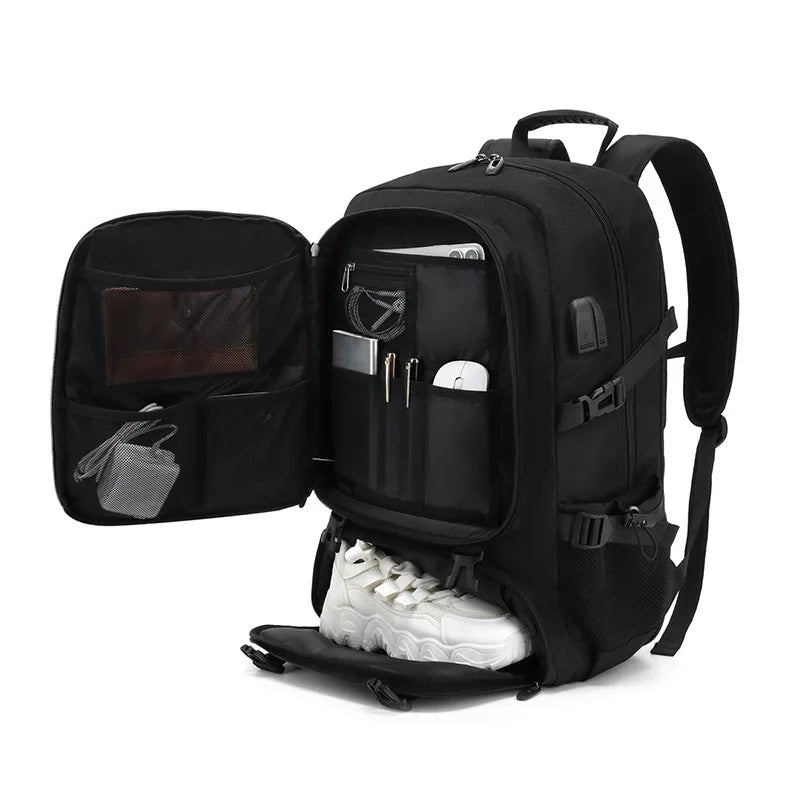 Black travel backpack open showing internal organization pockets and shoe compartment