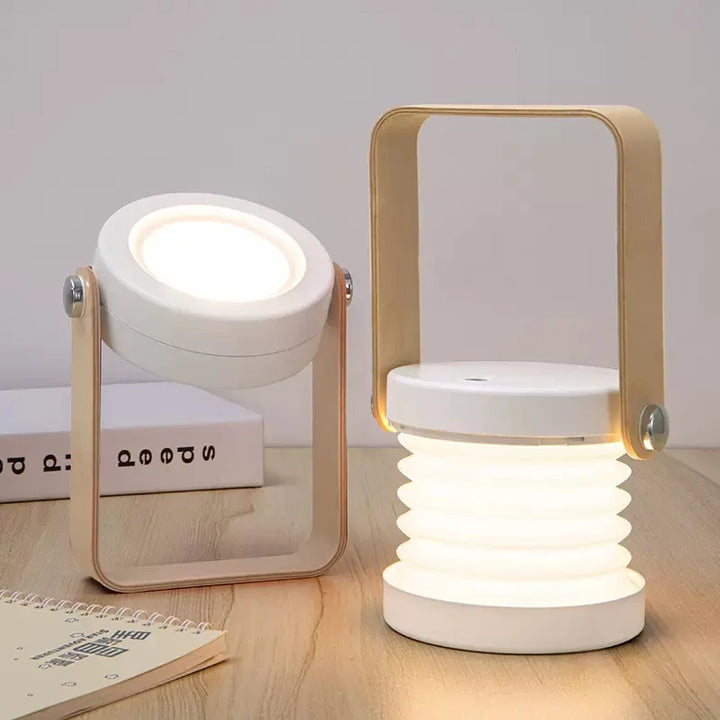 White wireless rechargeable table lamp displayed on a wooden surface with books