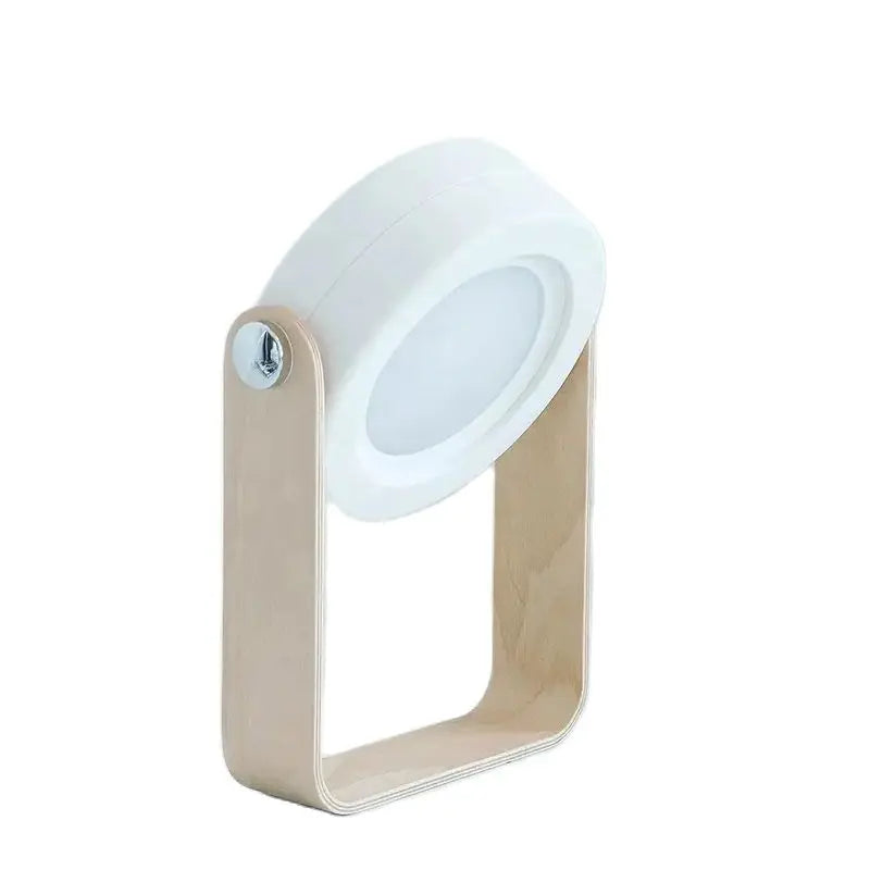 Rechargeable grey bedside light illuminating a cozy bedroom decor setting