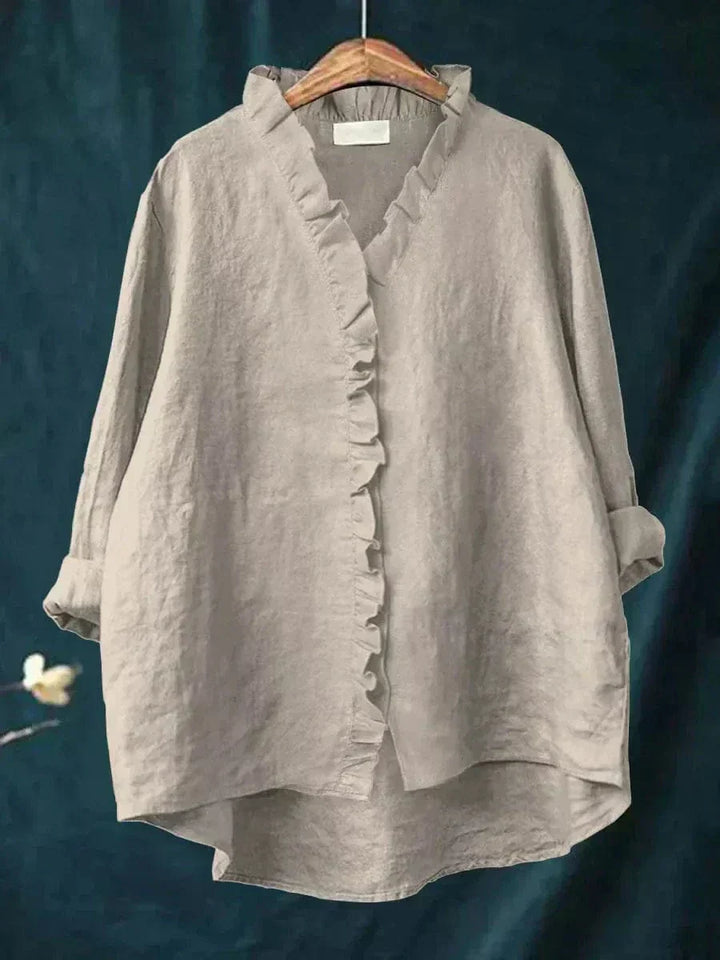Gray women's ruffle v-neck summer blouse hanging on a wooden hanger
