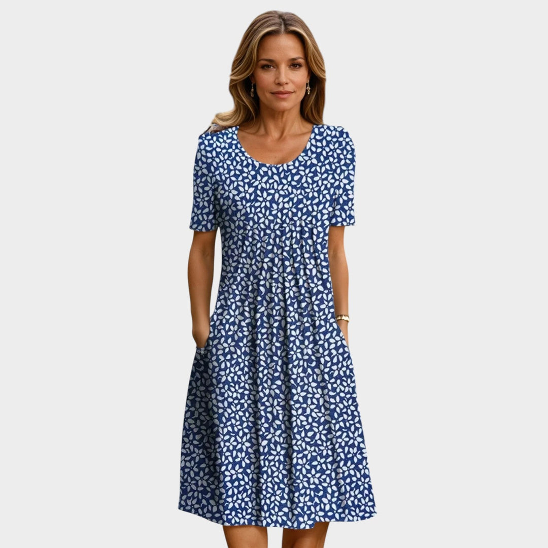 Woman wearing a blue midi dress with white floral pattern