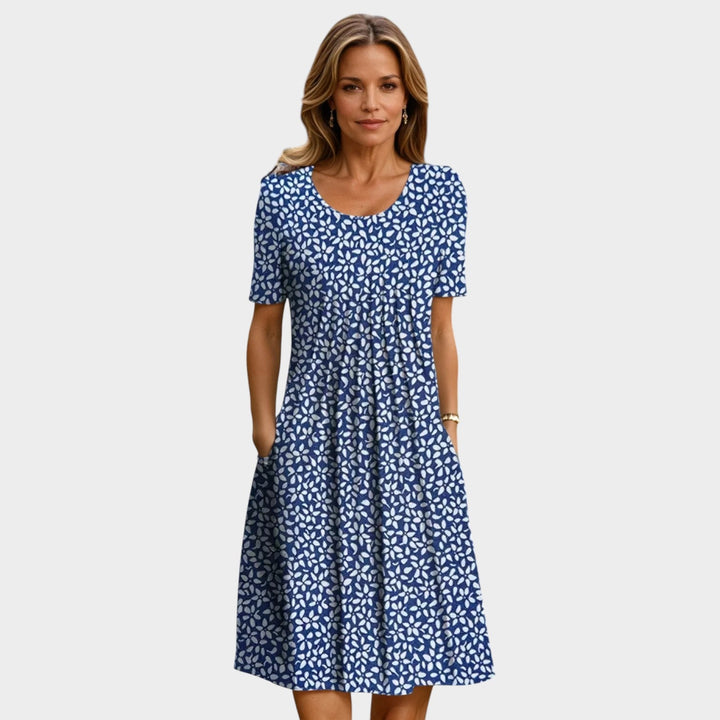 Woman wearing a blue midi dress with white floral pattern
