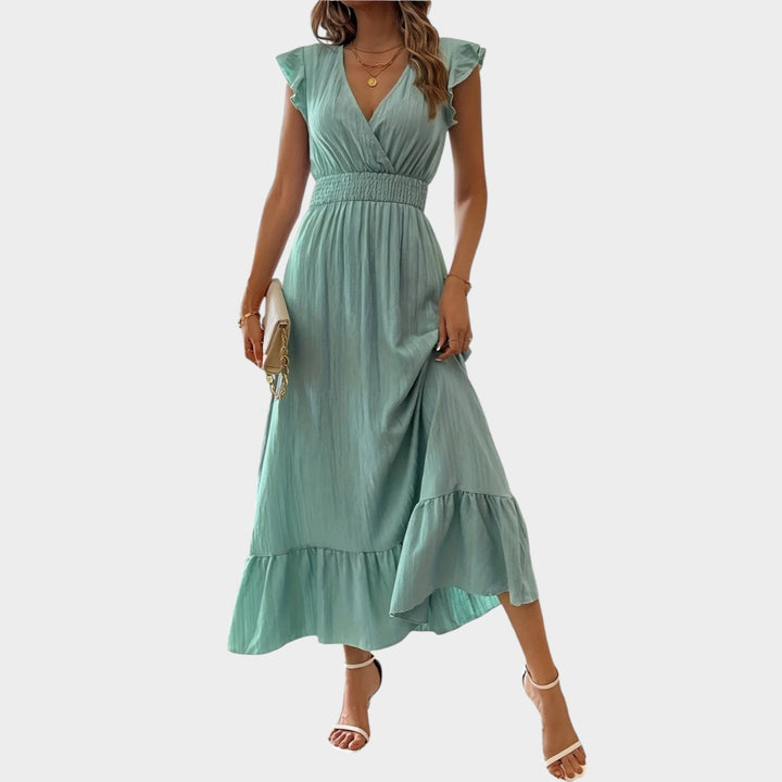 Woman wearing light green V-neck ruffle sleeve maxi dress