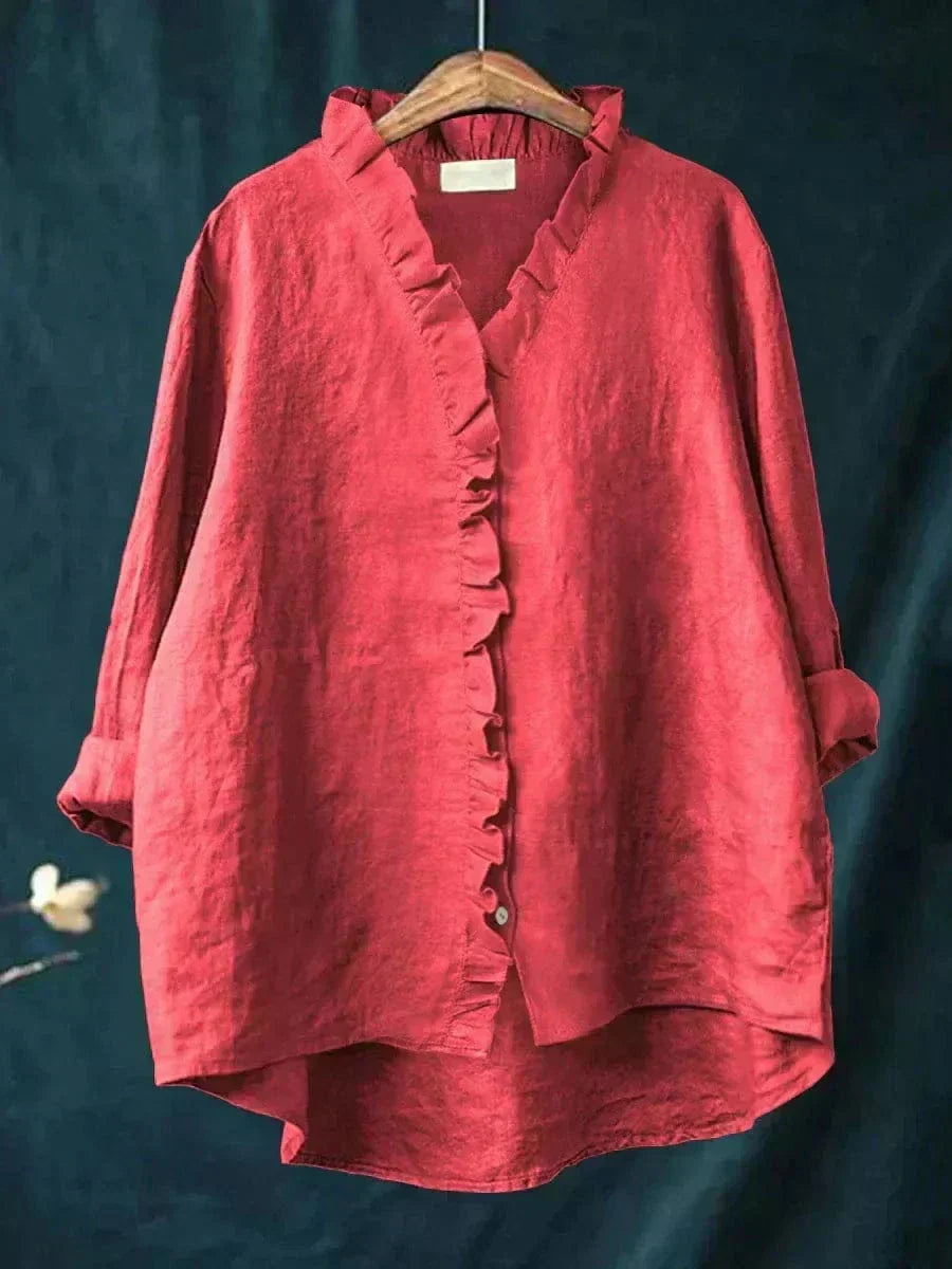 Red women's ruffle v-neck summer blouse hanging on a wooden hanger