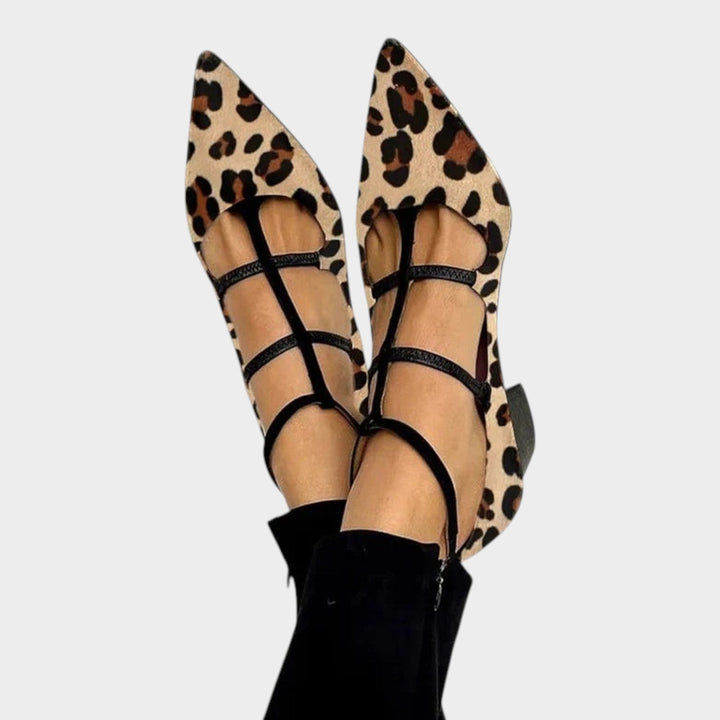 Top view of stylish women's leopard print strappy heeled shoes