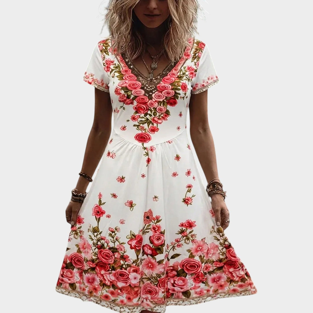 Front view of a woman wearing a white floral V-neck midi dress with short sleeves