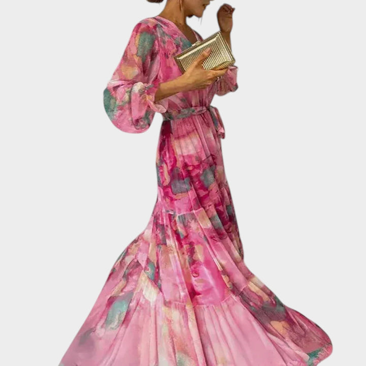 Side profile view of a woman wearing a long sleeve floral midi dress with tie waist