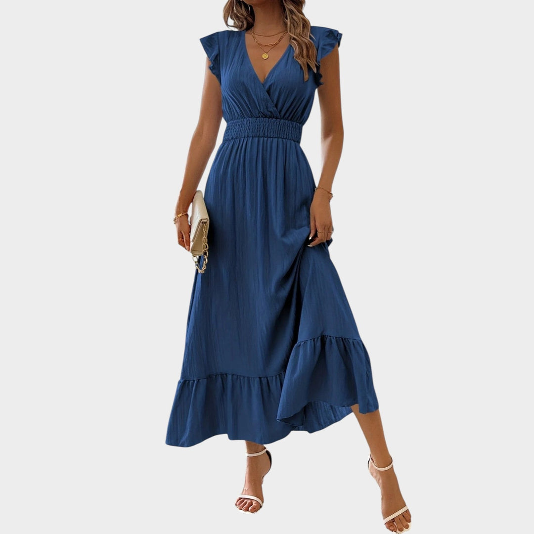 Woman wearing navy blue V-neck ruffle sleeve maxi dress