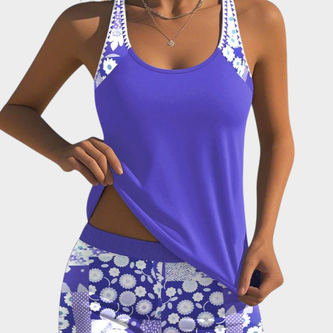 Woman wearing a lilac sleeveless tankini top and matching floral print shorts