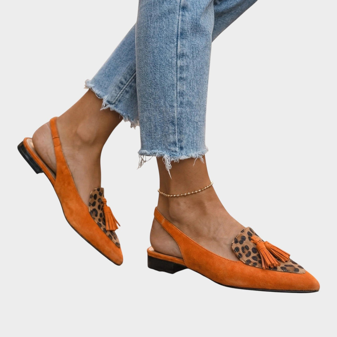 Close-up of the delicate ankle straps and secure buckle on casual women's tassel sandals.