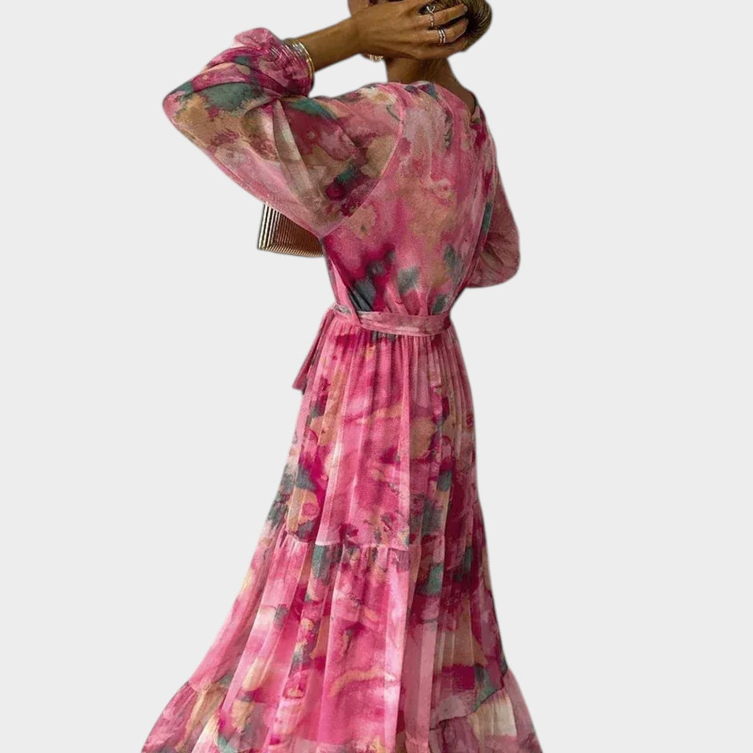 Back view of a woman wearing a tiered floral midi dress with long sleeves