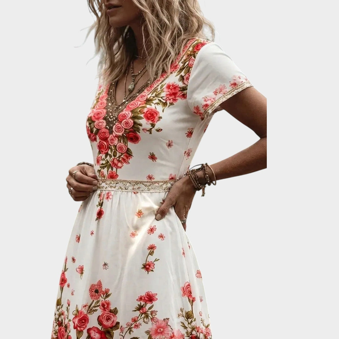 Close-up view of the V-neckline and detailed floral border on the dress