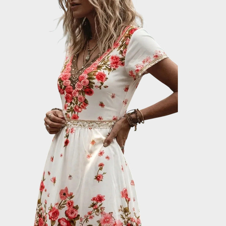 Close-up view of the V-neckline and detailed floral border on the dress