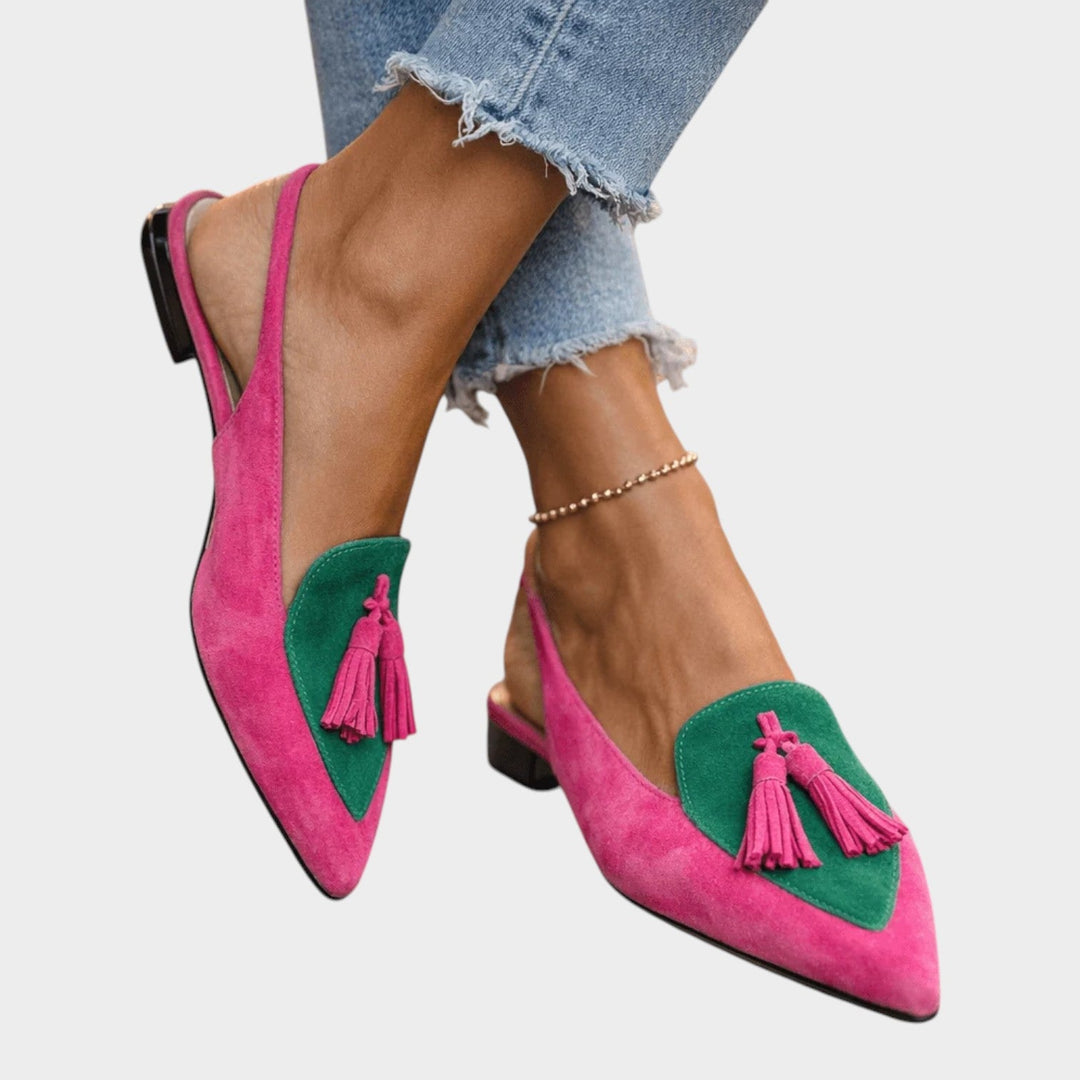 Women wearing pink and green strappy tassel flat sandals