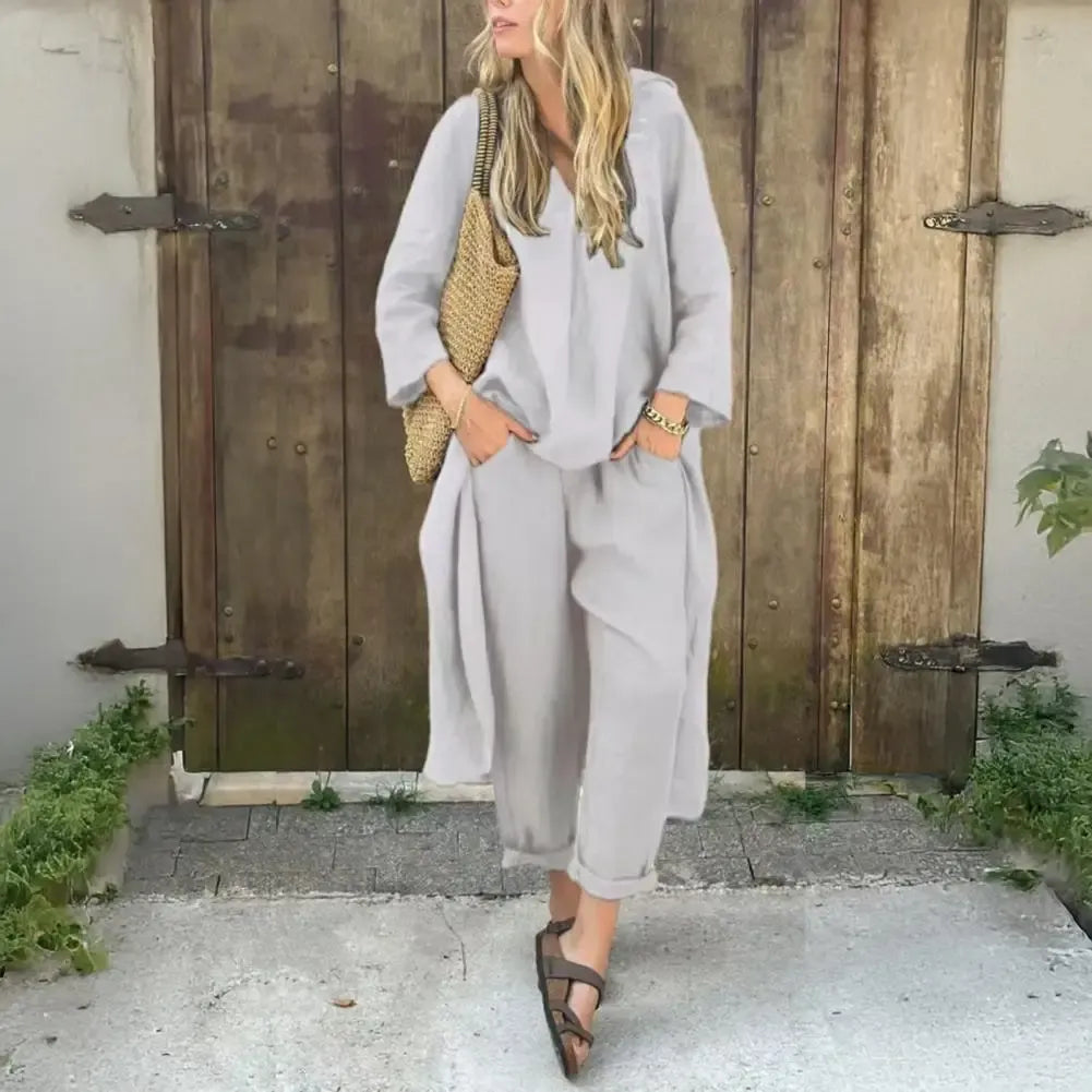 Woman wearing a light gray relaxed long vest and wide-leg pants set