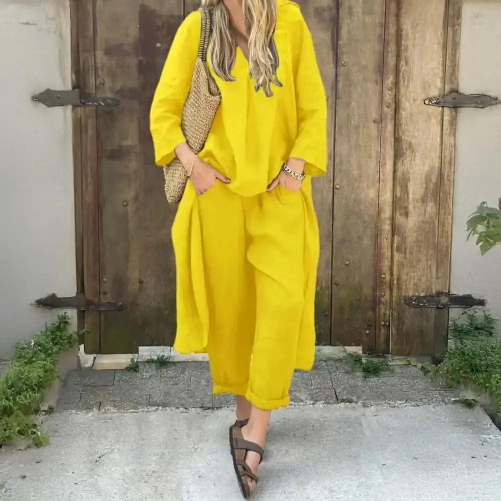 Woman wearing a vibrant yellow long vest and wide-leg pants set